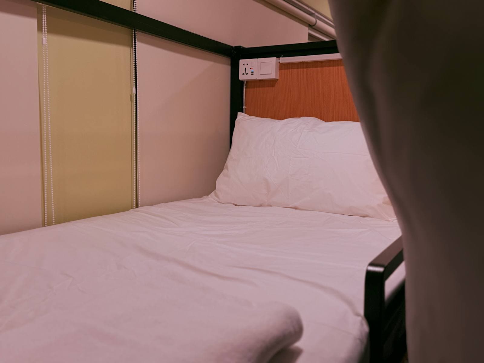Detail of a comfortable bed with white duvet