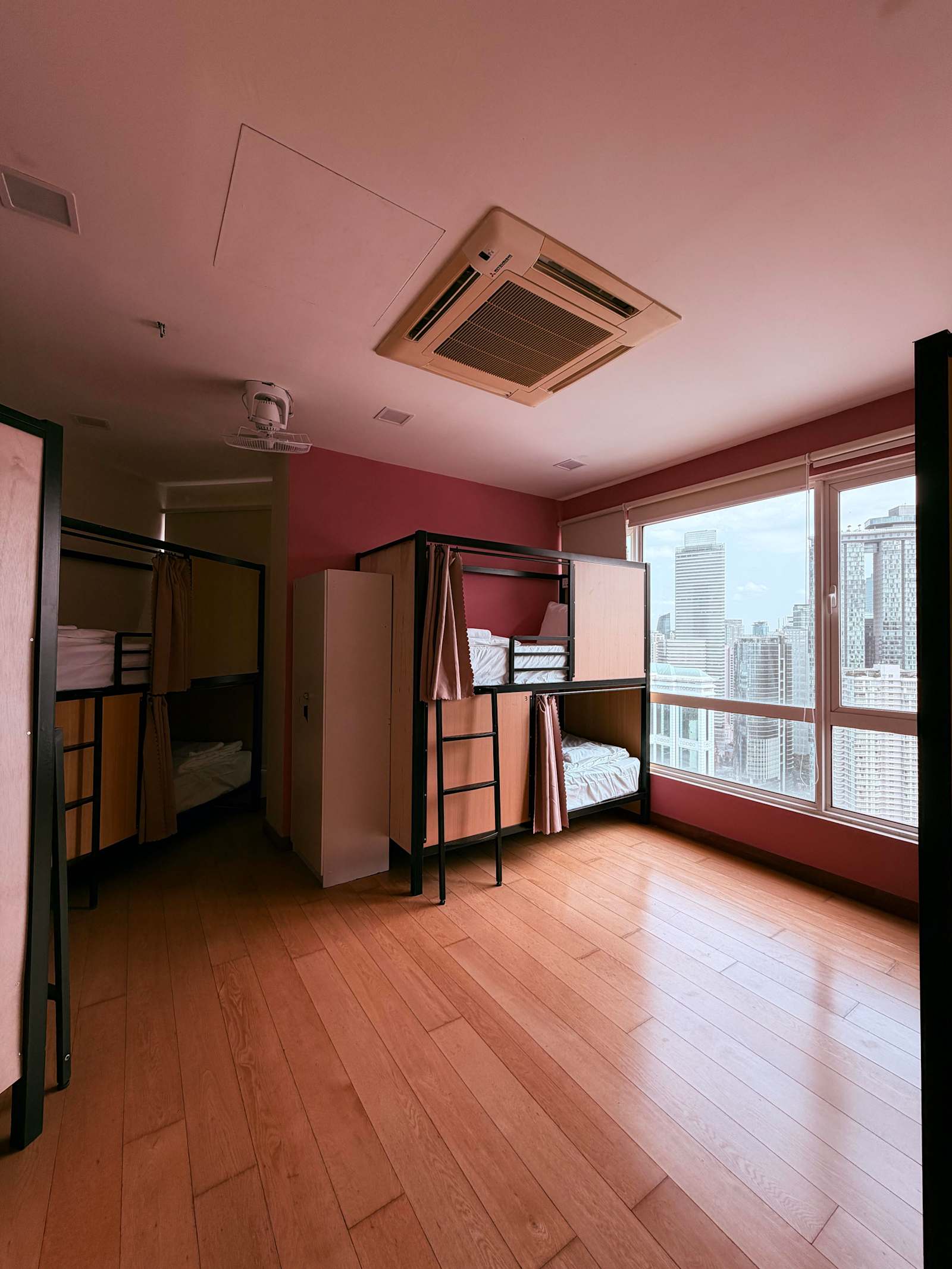 Dorm with bunk beds and floor-to-ceiling window