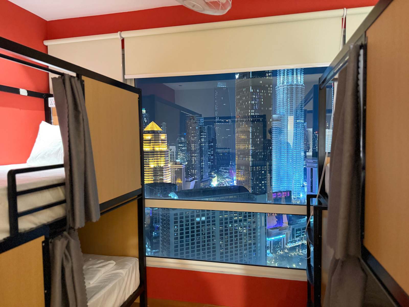 Dorm at night facing city lights