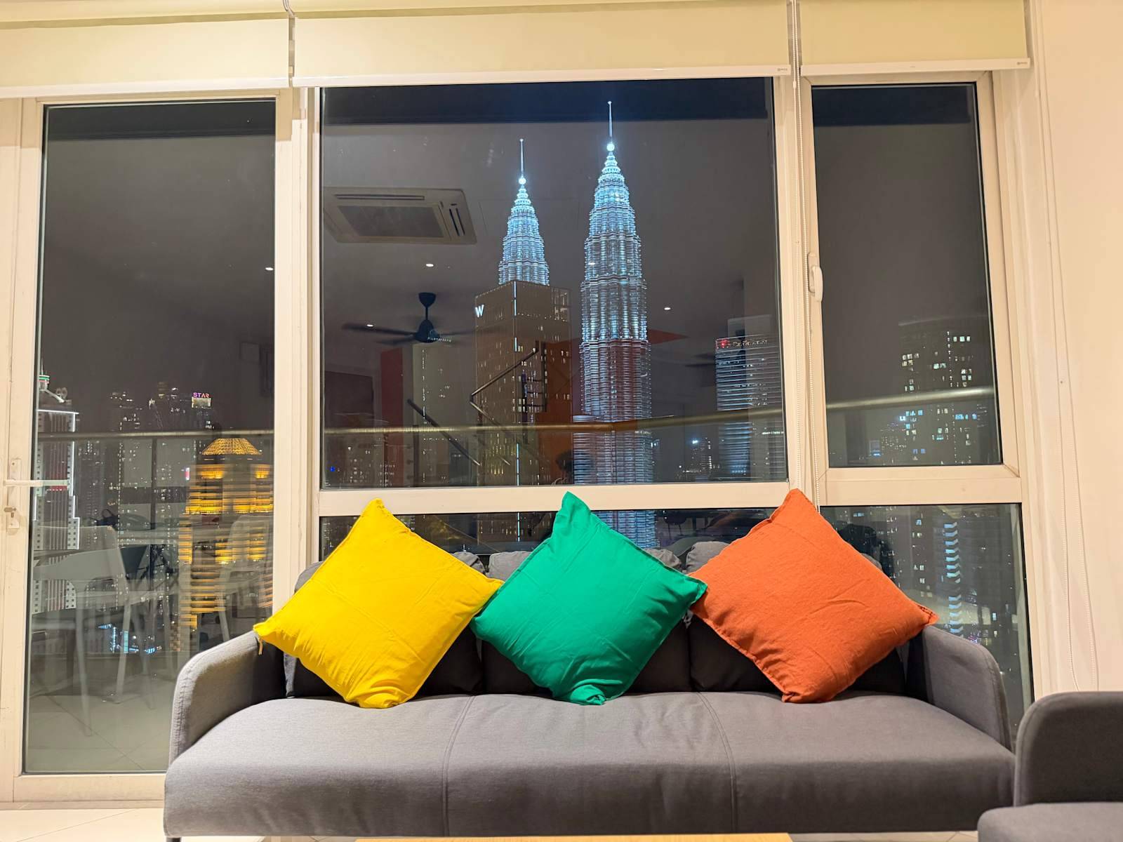 Hostel lounge with Petronas Twin Towers night view at Poshpack Skyline Kuala Lumpur
